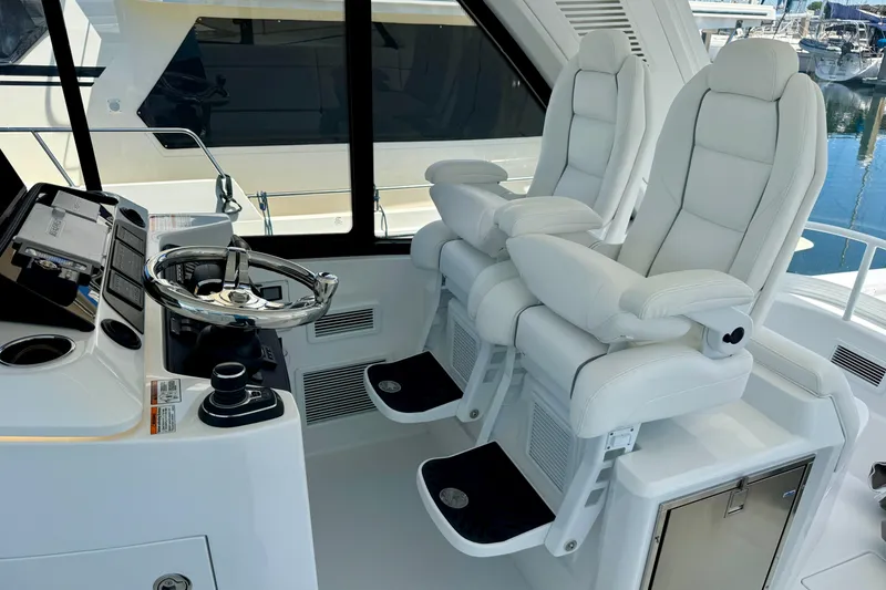 Slide: The Image of Luxury helm seats and steering wheel on 2025 Intrepid 50 Evolution yacht. - 25