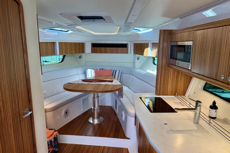 Slide: The Image of Luxurious interior of 2025 Intrepid 50 Evolution yacht with modern kitchen and seating area. - 26