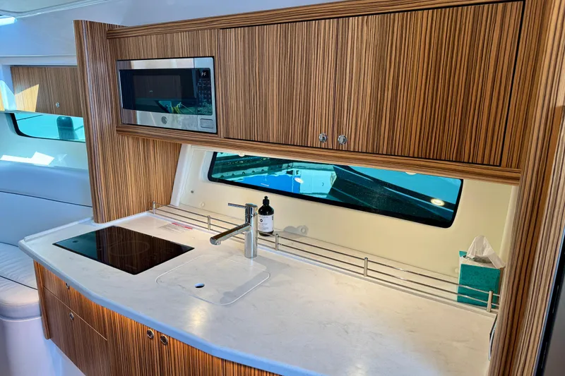 Slide: The Image of Modern kitchen in 2025 Intrepid 50 Evolution yacht with wood cabinetry and sleek appliances. - 27