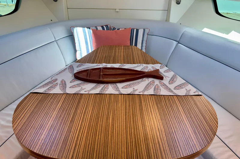 Slide: The Image of Luxurious interior of 2025 Intrepid 50 Evolution yacht with elegant wood table. - 28
