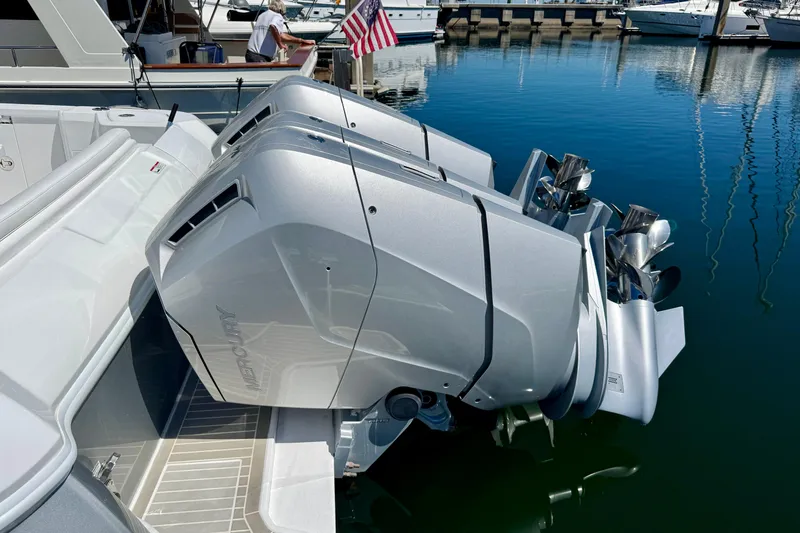 Slide: The Image of Twin Mercury outboard engines on a 2025 Intrepid 50 Evolution yacht docked in a marina. - 3