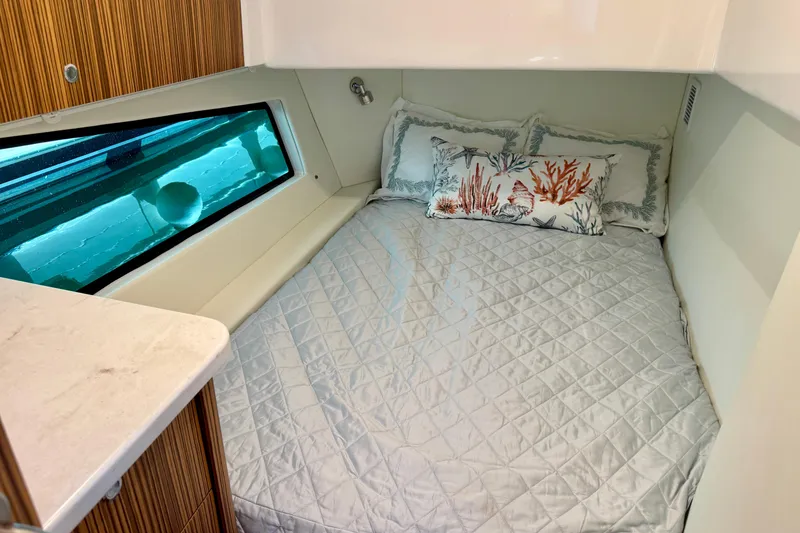 Slide: The Image of Cozy cabin interior of 2025 Intrepid 50 Evolution yacht with decorative pillows. - 30