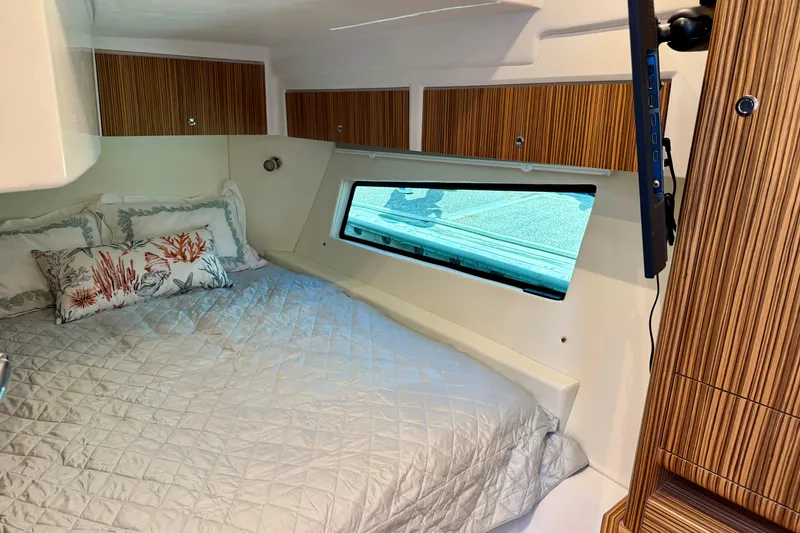 Slide: The Image of Luxurious cabin interior of 2025 Intrepid 50 Evolution yacht with cozy bedding. - 31
