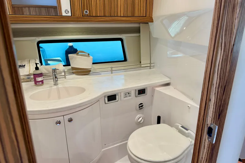 Slide: The Image of Luxurious bathroom interior of 2025 Intrepid 50 Evolution yacht, featuring modern fixtures and wood accents. - 34