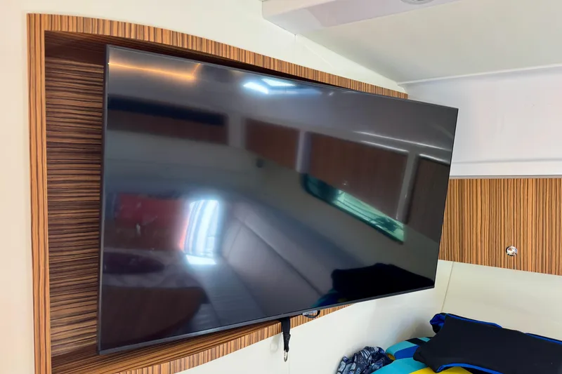 Slide: The Image of Flat-screen TV mounted in a 2025 Intrepid 50 Evolution yacht interior. - 36