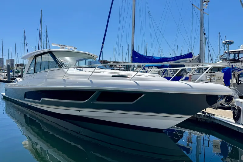 Slide: The Image of 2025 Intrepid 50 Evolution yacht docked in marina under clear blue sky. - 37