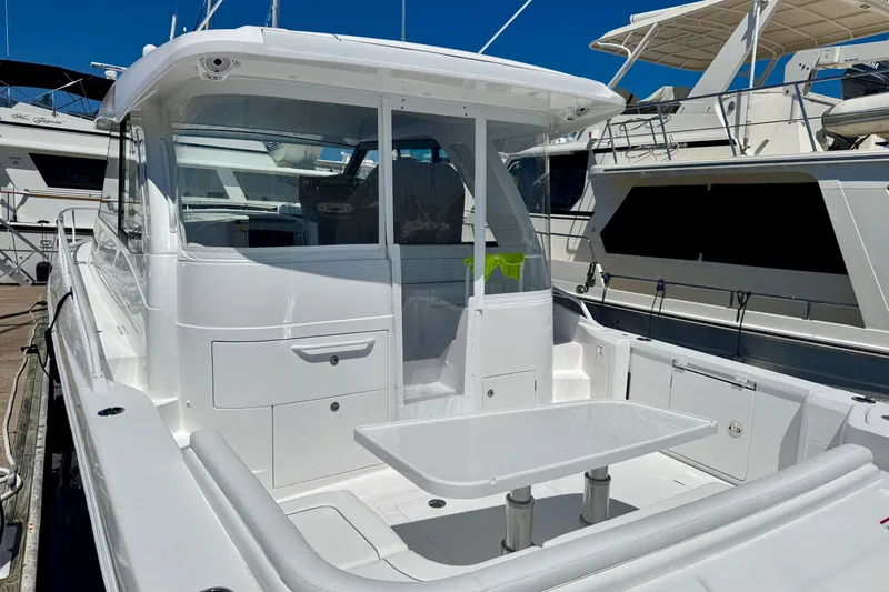 Slide: The Image of 2025 Intrepid 50 Evolution yacht docked, featuring sleek white design and spacious deck area. - 4