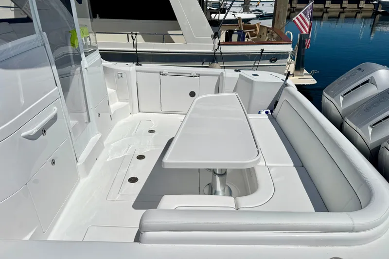Slide: The Image of Luxury seating area on 2025 Intrepid 50 Evolution yacht, docked with outboard engines. - 45
