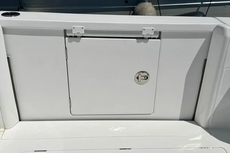Slide: The Image of Hatch door on 2025 Intrepid 50 Evolution boat, featuring sleek white design and secure latch. - 6