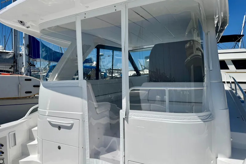 Slide: The Image of 2025 Intrepid 50 Evolution yacht with sleek white exterior and modern design. - 7