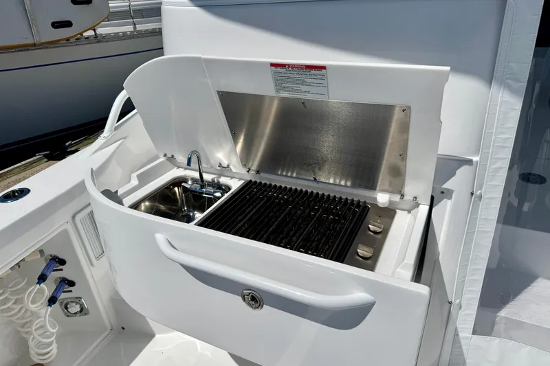 Slide: The Image of Outdoor kitchen on 2025 Intrepid 50 Evolution yacht with grill and sink. - 8