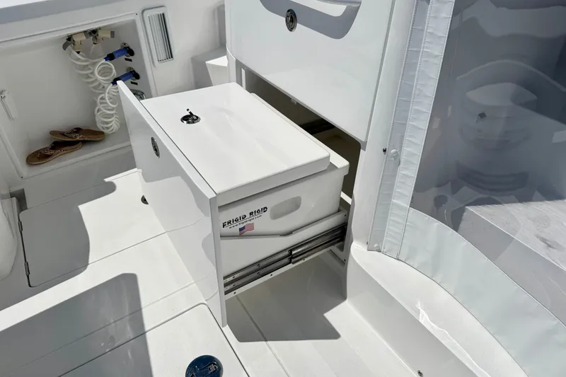 Slide: The Image of Intrepid 50 Evolution 2025 boat interior with storage compartment and hose. - 9