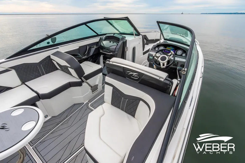 Slide: The Image of 2023 Monterey 255SS Super Sport boat interior with sleek seating and modern dashboard on calm water. - 27