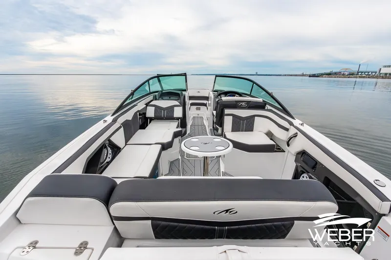 Slide: The Image of 2023 Monterey 255SS Super Sport boat interior with luxurious seating on calm water. - 22