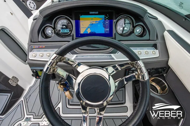 Slide: The Image of 2023 Monterey 255SS Super Sport dashboard with navigation display and sleek steering wheel. - 31
