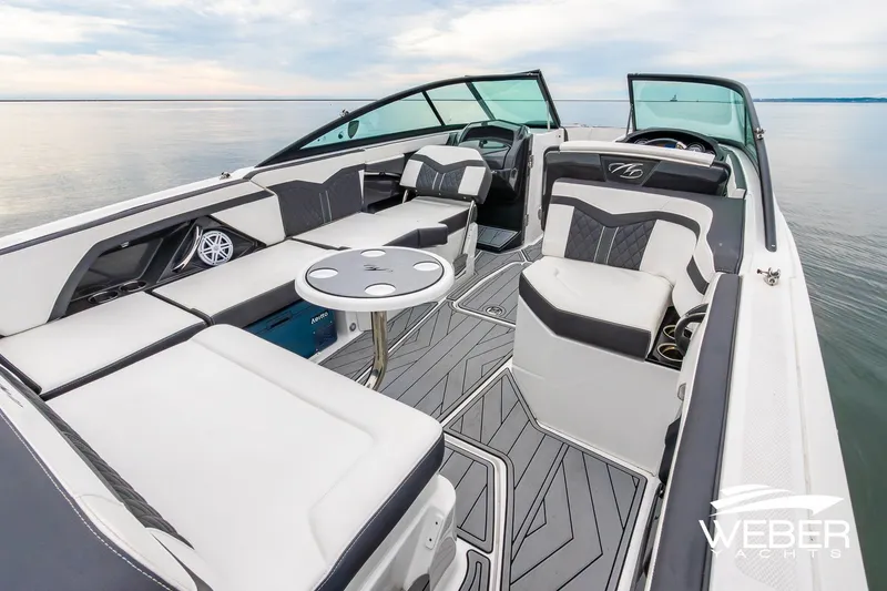 Slide: The Image of 2023 Monterey 255SS Super Sport boat interior with luxurious seating and sleek design on calm water. - 21