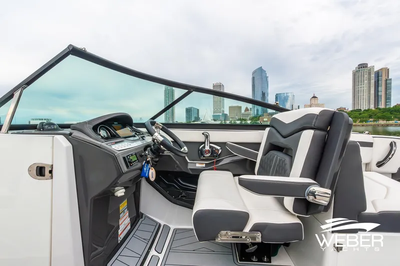 Slide: The Image of Cockpit of 2023 Monterey 255SS Super Sport boat with city skyline in background. - 28
