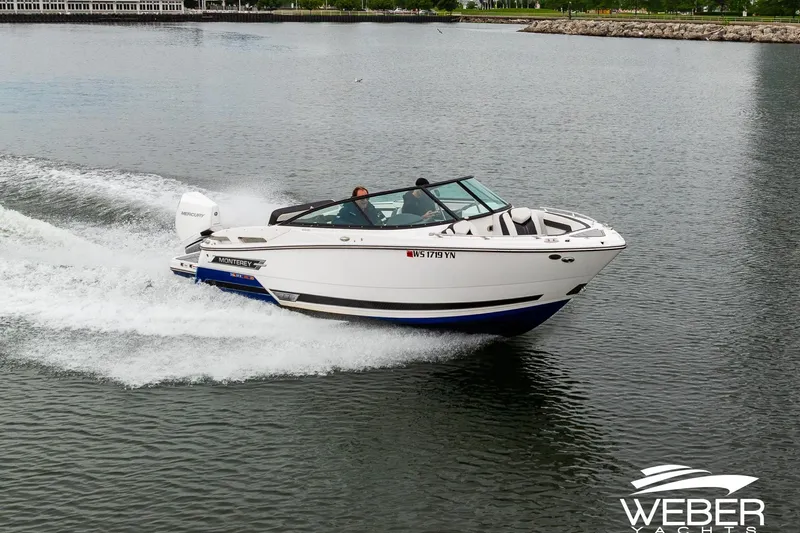 Slide: The Image of 2023 Monterey 255SS Super Sport boat cruising on a calm lake. - 3