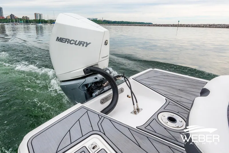 Slide: The Image of 2023 Monterey 255SS Super Sport with Mercury outboard engine on calm water. - 17