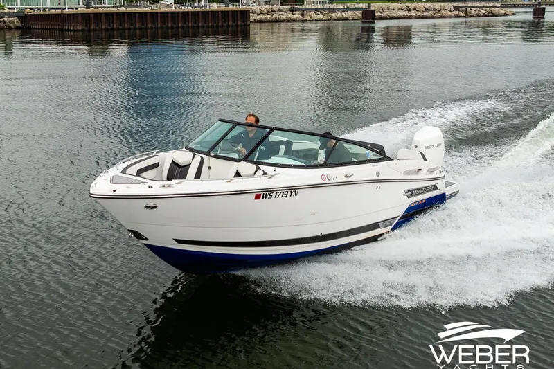 Slide: The Image of 2023 Monterey 255SS Super Sport boat cruising on water, showcasing sleek design and performance. - 2