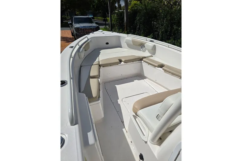 Slide: The Image of 2014 Everglades 243 Center Console boat interior with cushioned seating and white deck. - 12