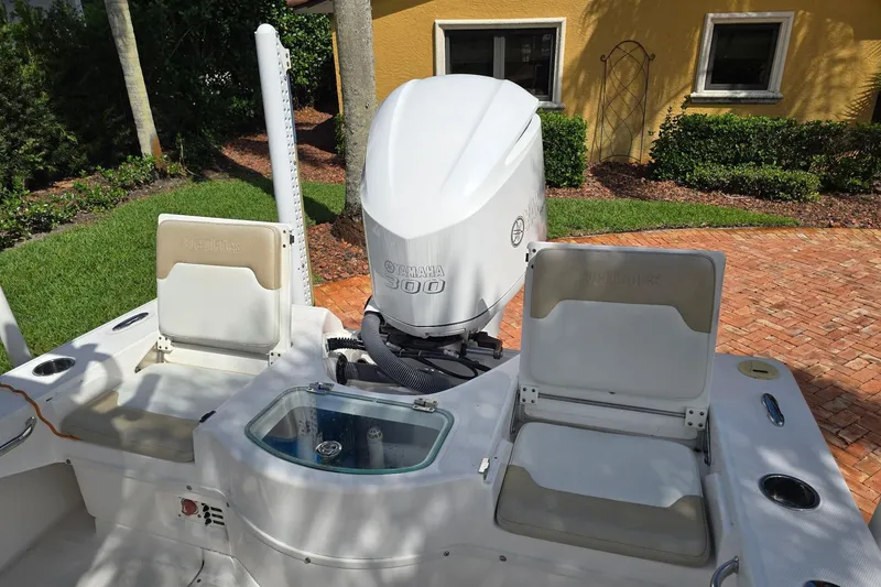 Slide: The Image of 2014 Everglades 243 Center Console boat with Yamaha 300 engine, parked on brick driveway. - 16