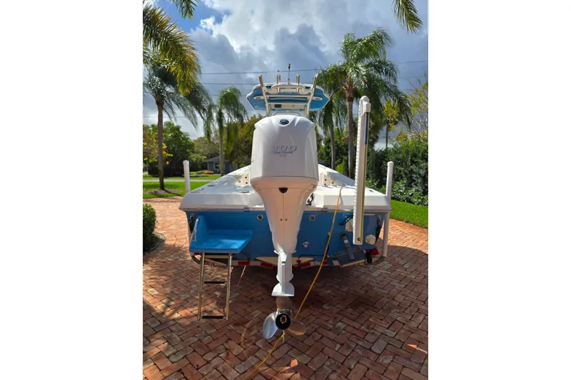 Slide: The Image of 2014 Everglades 243 Center Console boat with outboard motor on brick driveway. - 4