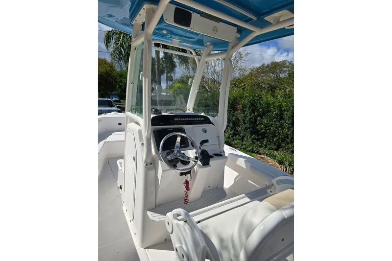 Slide: The Image of 2014 Everglades 243 Center Console boat interior with steering wheel and seating. - 5