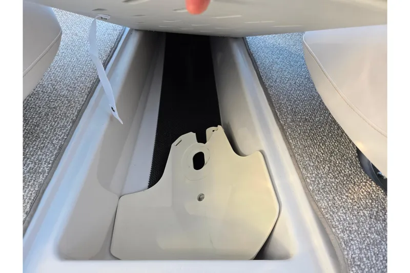 Slide: The Image of 2016 Glastron GT 185 boat interior storage compartment with carpeted flooring. - 12
