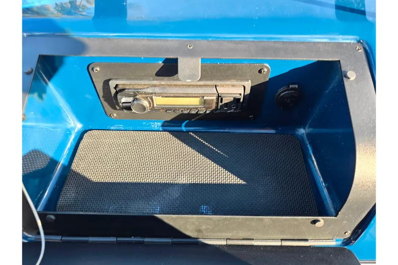 Slide: The Image of 2016 Glastron GT 185 boat dashboard with stereo system and blue interior. - 15