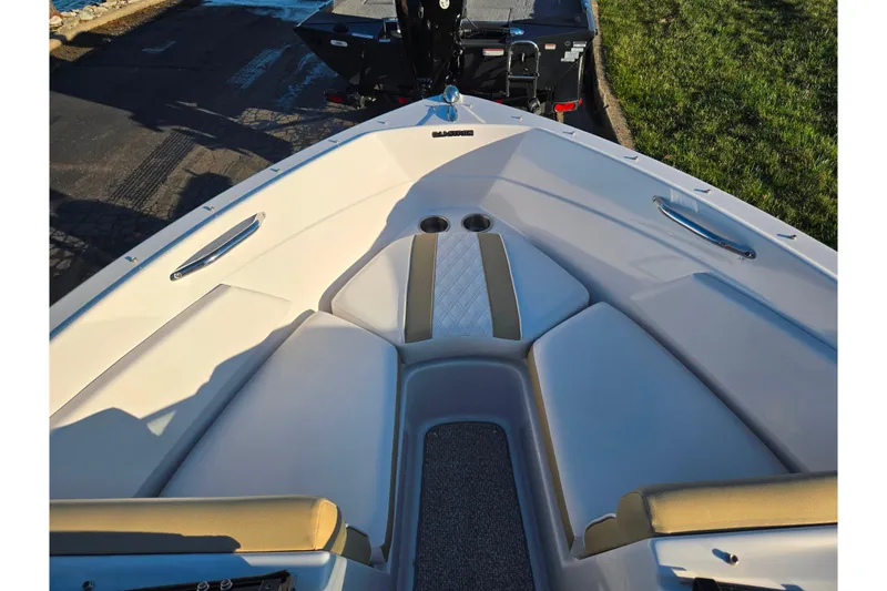 Slide: The Image of 2016 Glastron GT 185 boat interior with cushioned seating and cup holders. - 16