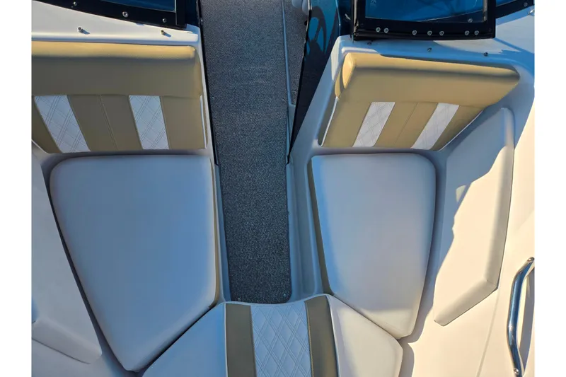 Slide: The Image of 2016 Glastron GT 185 boat interior with beige and white cushioned seating. - 17