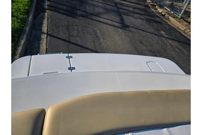 Slide: The Image of 2016 Glastron GT 185 boat deck, featuring white and beige upholstery. - 23