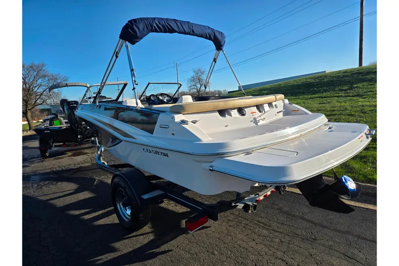 Slide: The Image of 2016 Glastron GT 185 boat on trailer, sunny day, blue sky background. - 3