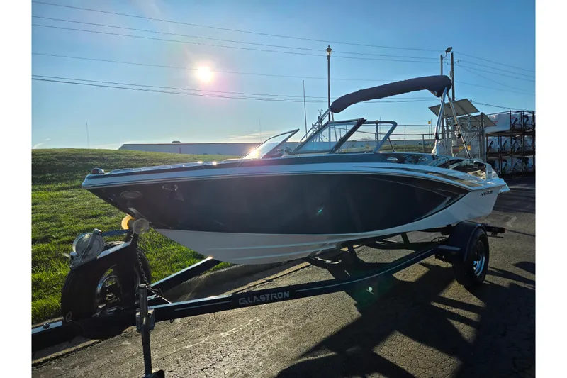 Slide: The Image of 2016 Glastron GT 185 boat on trailer under bright sun. - 5
