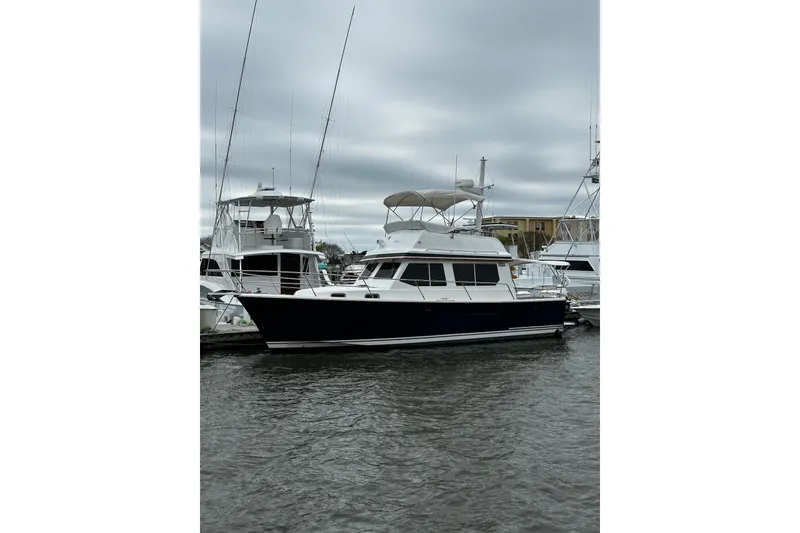 The Image of 2001 Sabre 34 yacht docked at marina under cloudy sky. - 0