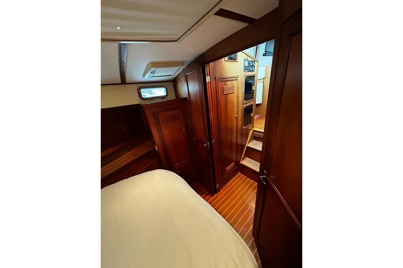 Slide: The Image of Interior of 2001 Sabre 34 yacht with wooden cabinetry and cozy sleeping area. - 11