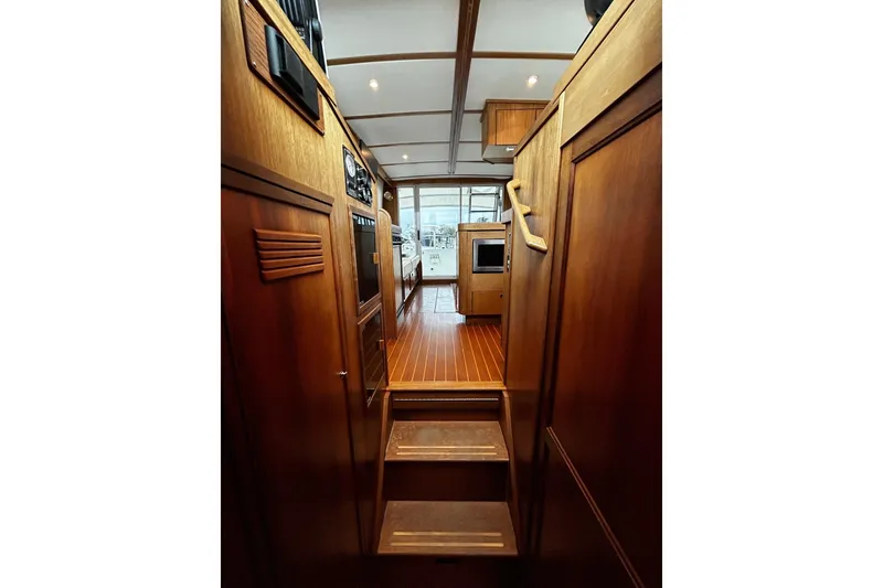 Slide: The Image of Interior view of 2001 Sabre 34 yacht, featuring wooden cabinetry and flooring. - 13