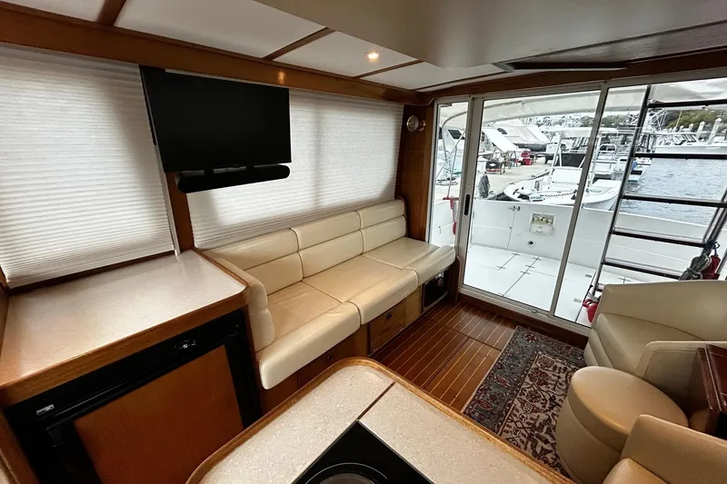 Slide: The Image of Interior of 2001 Sabre 34 yacht with seating, TV, and marina view. - 16