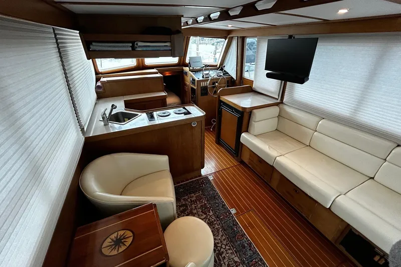 Slide: The Image of Luxurious interior of a 2001 Sabre 34 yacht with seating, kitchenette, and TV. - 17