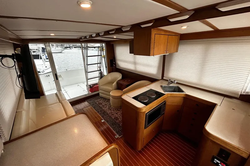 Slide: The Image of Interior of 2001 Sabre 34 yacht with kitchen, seating, and marina view. - 18