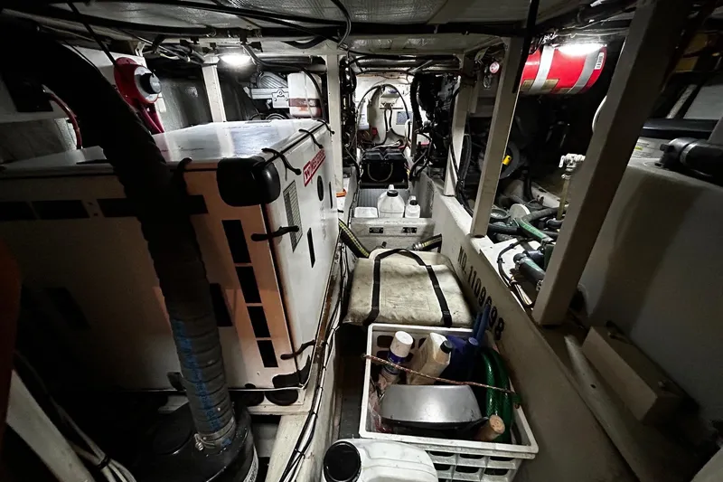 Slide: The Image of Engine room of a 2001 Sabre 34 boat, featuring equipment and storage. - 24