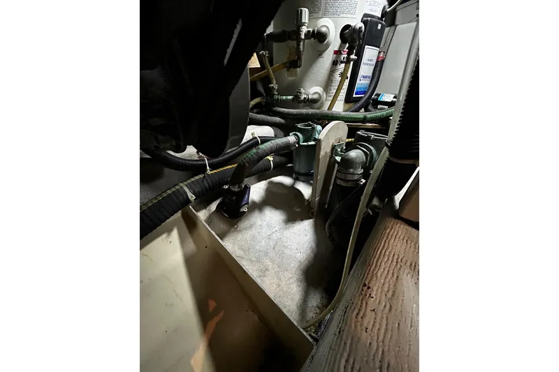 Slide: The Image of Engine compartment of a 2001 Sabre 34 boat, showcasing hoses and mechanical components. - 25