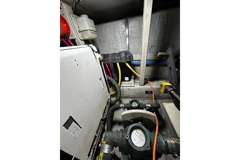 Slide: The Image of Engine room of a 2001 Sabre 34 boat with visible machinery and wiring. - 28