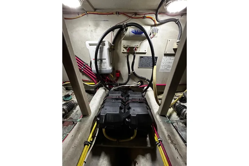Slide: The Image of Engine compartment of a 2001 Sabre 34 boat, featuring wiring and battery setup. - 30