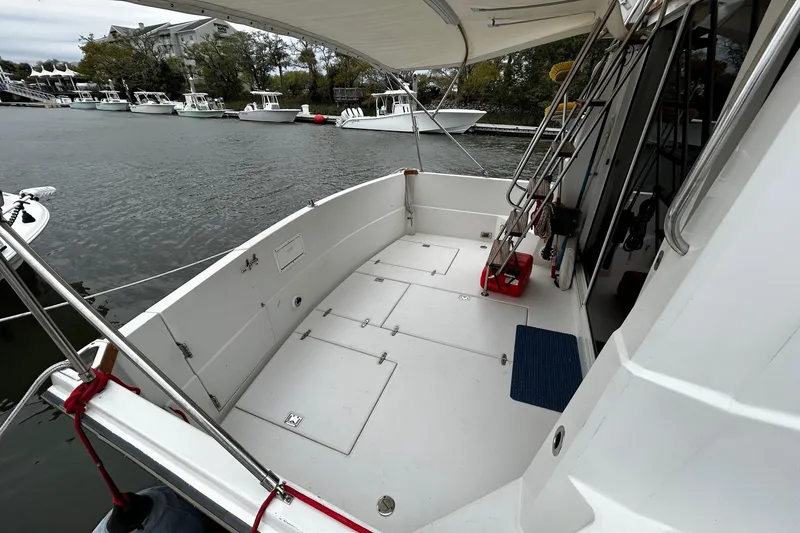 Slide: The Image of Spacious deck of a 2001 Sabre 34 boat docked by the water. - 5