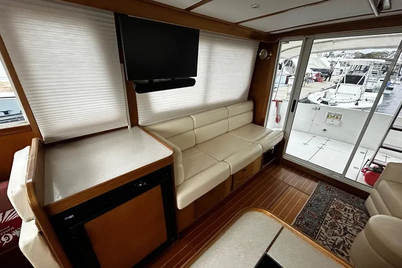 Slide: The Image of Interior of 2001 Sabre 34 yacht with seating, TV, and marina view. - 9