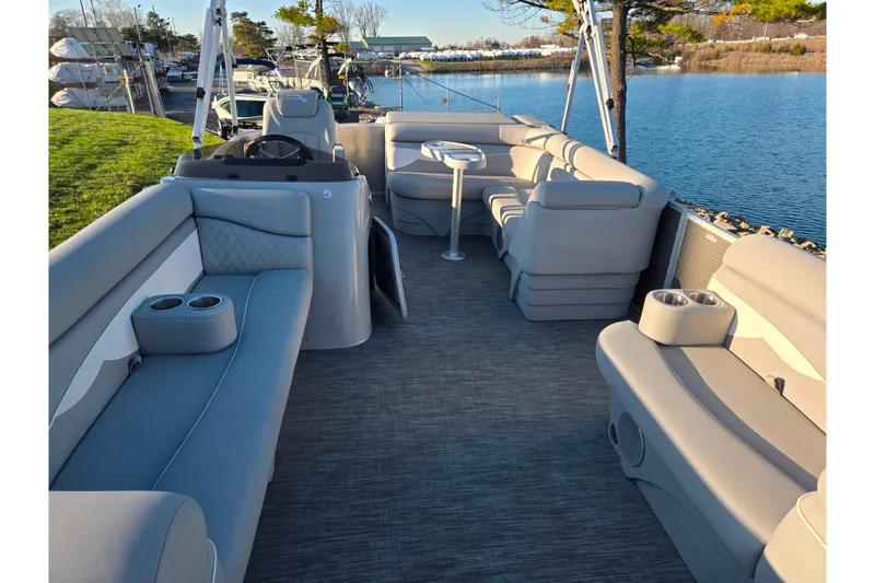 Slide: The Image of 2021 Bennington S 20 L-Bench pontoon boat with spacious seating and scenic lake view. - 10