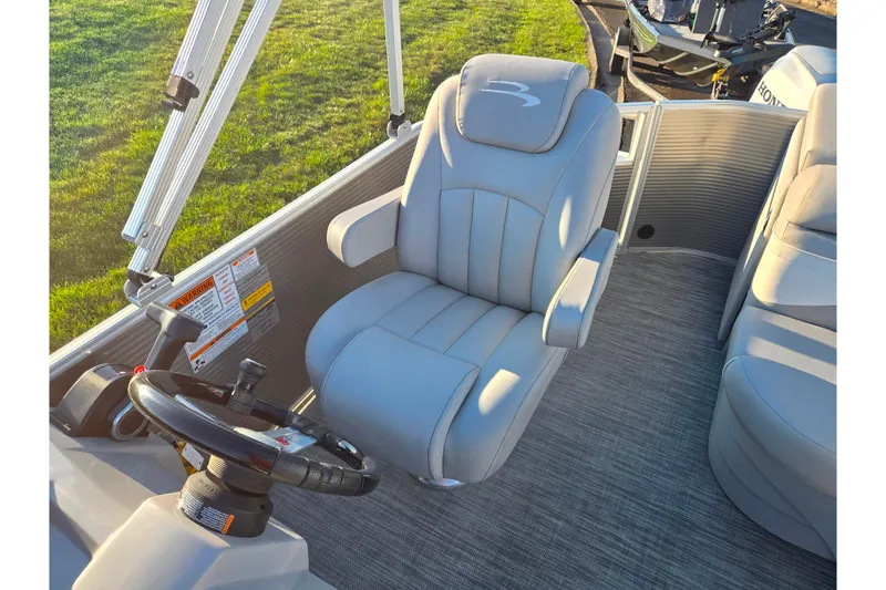 Slide: The Image of 2021 Bennington S 20 L-Bench boat interior with steering wheel and captain's chair. - 14
