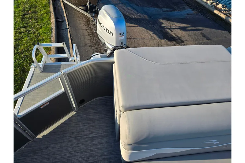 Slide: The Image of 2021 Bennington S 20 L-Bench pontoon boat with Honda motor, docked on a sunny day. - 16